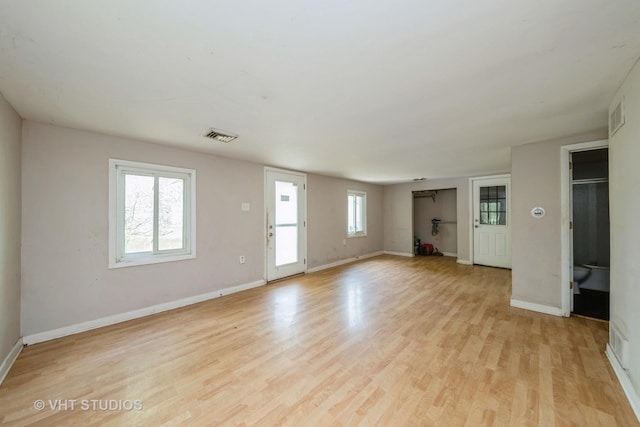 561 S Drive Drive S, Elgin, IL 60177 - unfurnished living room featuring light wood-style flooring and baseboards