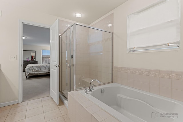 ensuite bathroom featuring tile patterned flooring, ensuite bath, a shower stall, and a bath