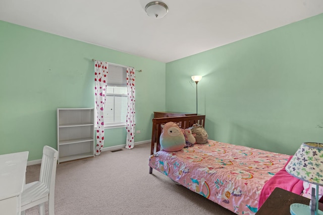 bedroom featuring baseboards, visible vents, and carpet