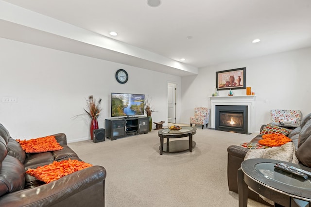 carpeted living area with baseboards, a fireplace with flush hearth, and recessed lighting