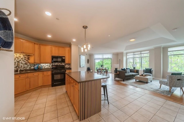 40 Prairie Park Dr Unit 206, Wheeling, IL 60090 - kitchen featuring black appliances, tasteful backsplash, dark countertops, plenty of natural light, and recessed lighting