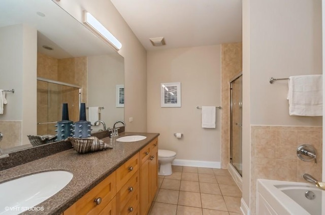 40 Prairie Park Dr Unit 206, Wheeling, IL 60090 - full bathroom with tile patterned flooring, a stall shower, double vanity, toilet, and a garden tub
