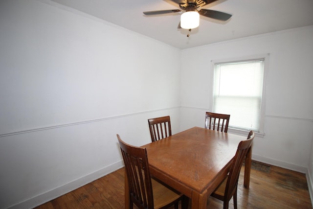 dining space featuring wood finished floors, baseboards, ornamental molding, and ceiling fan