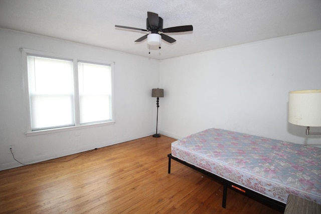 bedroom with wood finished floors and a ceiling fan