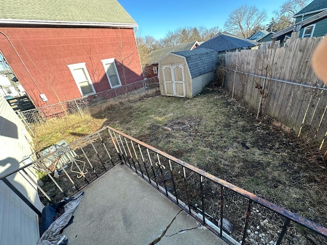 fenced backyard featuring a storage shed and an outdoor structure