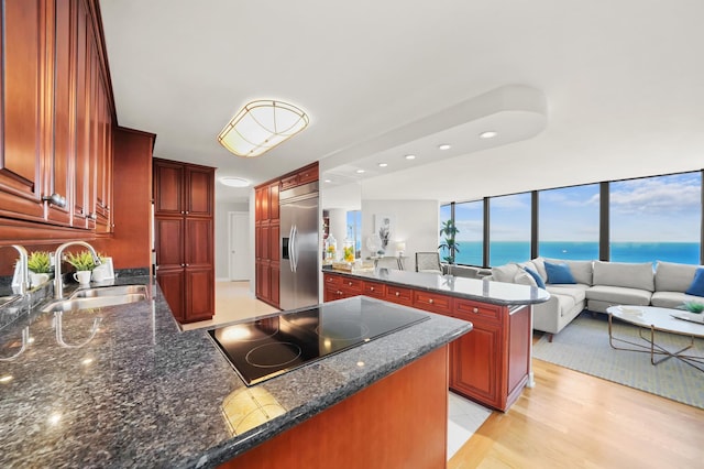 505 N Lake Shore Dr Unit 6304-6305, Chicago, IL 60611 - kitchen featuring a peninsula, dark brown cabinets, stainless steel built in fridge, a sink, and black electric cooktop