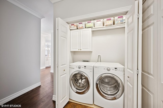 1122 N Dearborn St Unit 10A, Chicago, IL 60610 - clothes washing area featuring washing machine and dryer, cabinet space, crown molding, baseboards, and dark wood-style floors
