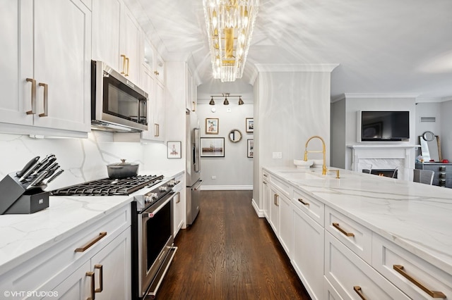 1122 N Dearborn St Unit 10A, Chicago, IL 60610 - kitchen with dark wood finished floors, a sink, a chandelier, high quality appliances, and white cabinets