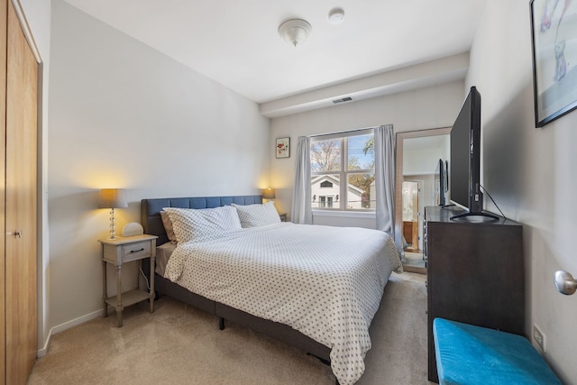 bedroom featuring light carpet, baseboards, and visible vents