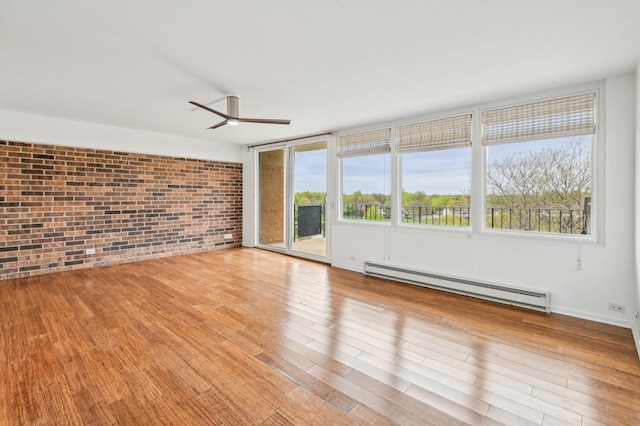 101 Bar Harbour Rd Unit 6N, Schaumburg, IL 60193 - unfurnished room featuring baseboard heating, brick wall, ceiling fan, wood finished floors, and healthy amount of natural light
