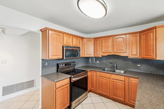101 Bar Harbour Rd Unit 6N, Schaumburg, IL 60193 - kitchen featuring appliances with stainless steel finishes, a sink, light tile patterned floors, and decorative backsplash