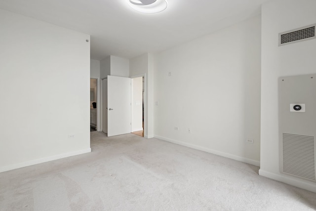 empty room with light colored carpet and baseboards