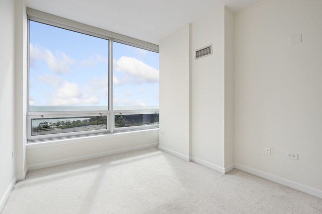 empty room with carpet floors and baseboards