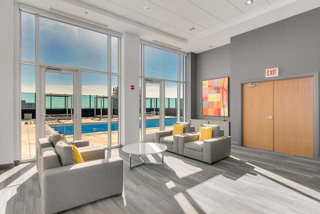 lobby featuring a towering ceiling and a drop ceiling