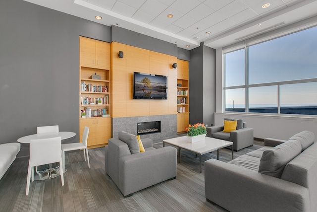 living room with built in shelves, a fireplace, and baseboards