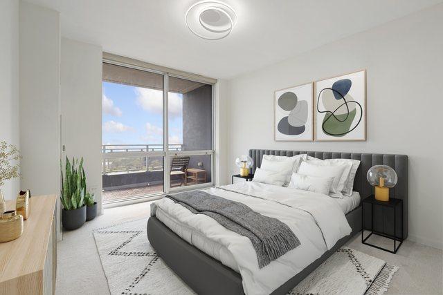 carpeted bedroom with expansive windows and access to outside