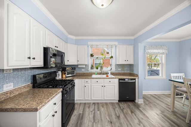 1612 Gardner Rd, Westchester, IL 60154 - kitchen featuring black appliances, a sink, light wood-style flooring, tasteful backsplash, and white cabinetry
