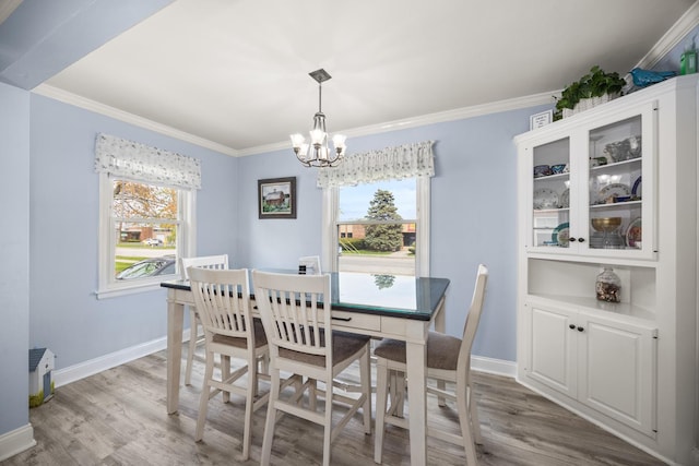 1612 Gardner Rd, Westchester, IL 60154 - dining space featuring a chandelier, light wood-style flooring, healthy amount of natural light, baseboards, and crown molding