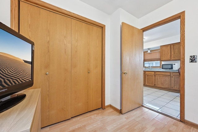 2740 W 35th Pl, Chicago, IL 60632 - unfurnished bedroom featuring light wood finished floors, a closet, a sink, and baseboards
