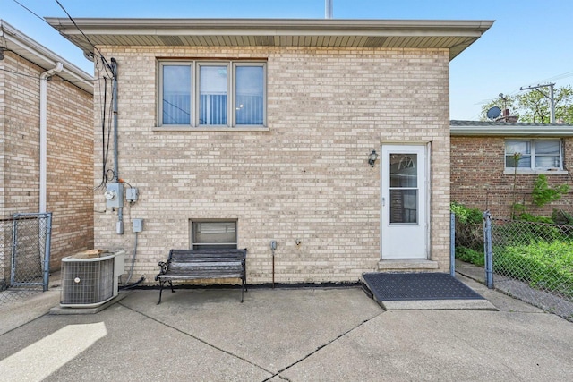 2740 W 35th Pl, Chicago, IL 60632 - back of house featuring fence, a patio area, central AC, and brick siding