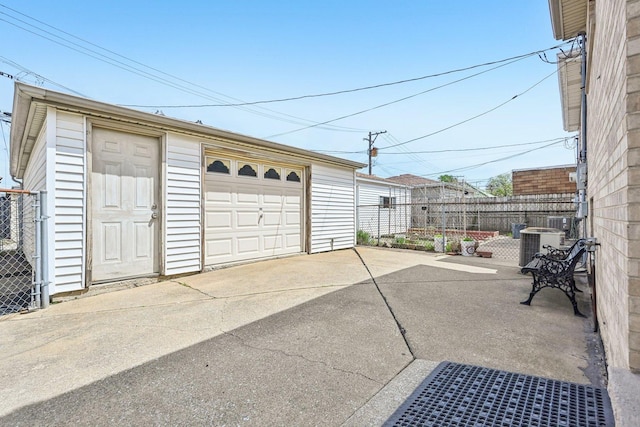 2740 W 35th Pl, Chicago, IL 60632 - detached garage with fence, central AC unit, and concrete driveway