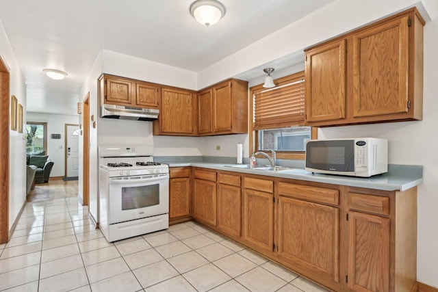 2740 W 35th Pl, Chicago, IL 60632 - kitchen with white appliances, a sink, under cabinet range hood, and light countertops