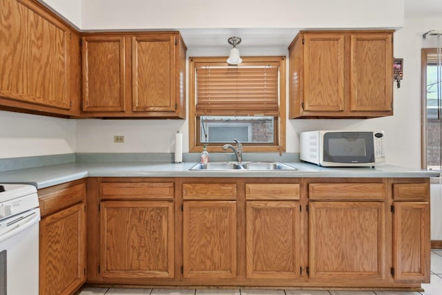 2740 W 35th Pl, Chicago, IL 60632 - kitchen featuring white appliances, a sink, light countertops, and brown cabinets