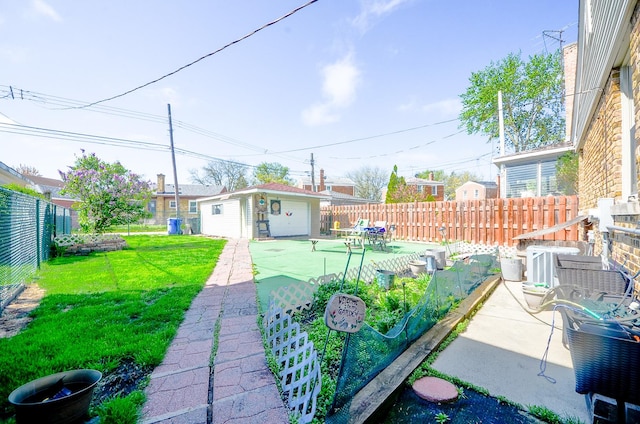 view of yard with an outdoor structure, a patio area, and a fenced backyard