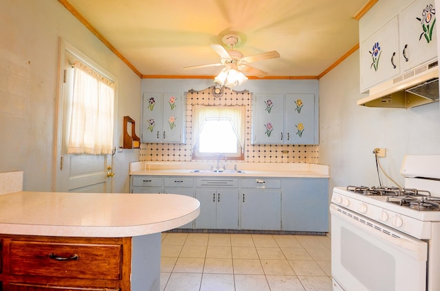 kitchen with under cabinet range hood, crown molding, white gas stove, and a sink