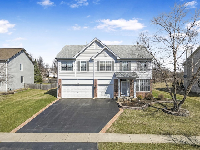 536 W Caldwell Dr, Round Lake, IL 60073 - view of front facade with a front yard, a garage, brick siding, and driveway