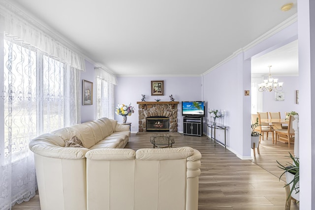 536 W Caldwell Dr, Round Lake, IL 60073 - living room with a notable chandelier, baseboards, crown molding, wood finished floors, and a fireplace