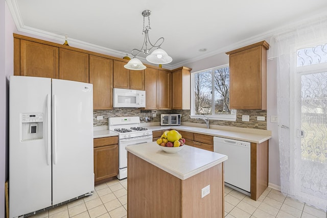 536 W Caldwell Dr, Round Lake, IL 60073 - kitchen with a sink, white appliances, crown molding, light countertops, and light tile patterned floors