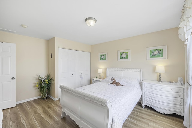 536 W Caldwell Dr, Round Lake, IL 60073 - bedroom with a closet, baseboards, and light wood-style floors