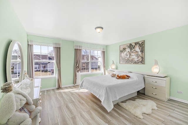 536 W Caldwell Dr, Round Lake, IL 60073 - bedroom with multiple windows, light wood-style floors, and baseboards