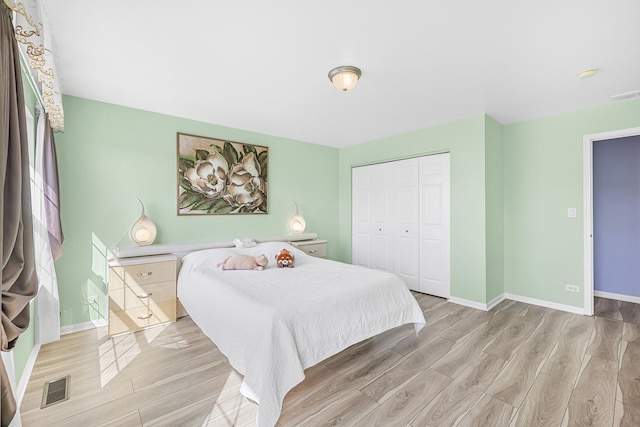 536 W Caldwell Dr, Round Lake, IL 60073 - bedroom with baseboards, a closet, light wood finished floors, and visible vents