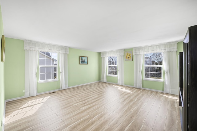 536 W Caldwell Dr, Round Lake, IL 60073 - unfurnished room featuring baseboards and light wood-style flooring