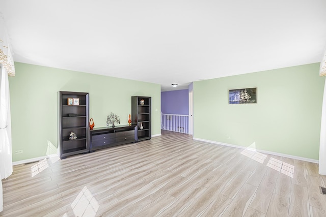 536 W Caldwell Dr, Round Lake, IL 60073 - unfurnished living room with light wood finished floors, baseboards, and visible vents