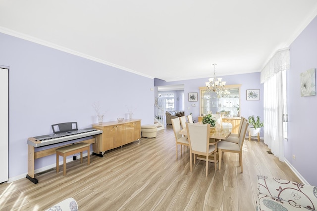 536 W Caldwell Dr, Round Lake, IL 60073 - dining space with an inviting chandelier, light wood-style floors, baseboards, and crown molding