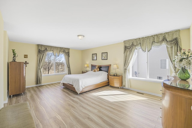 536 W Caldwell Dr, Round Lake, IL 60073 - bedroom with baseboards, light wood-style floors, and visible vents