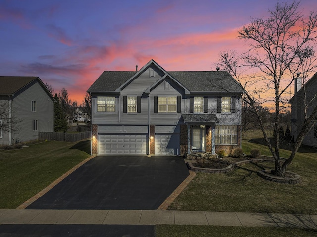 536 W Caldwell Dr, Round Lake, IL 60073 - traditional-style home featuring a lawn, a garage, brick siding, and driveway