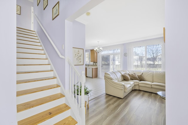 536 W Caldwell Dr, Round Lake, IL 60073 - stairway featuring a chandelier and wood finished floors