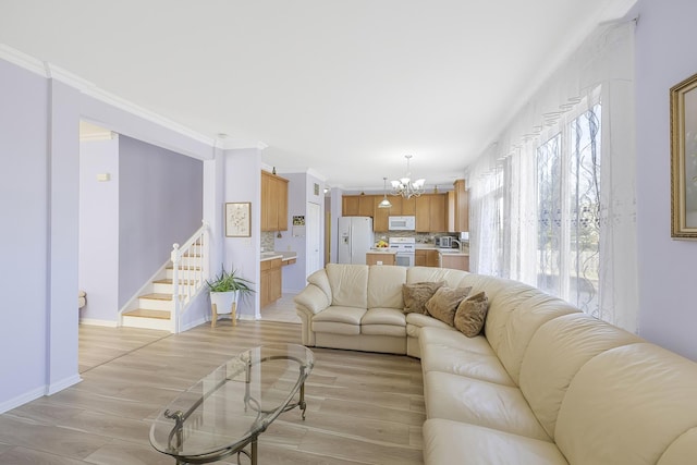 536 W Caldwell Dr, Round Lake, IL 60073 - living area featuring crown molding, stairway, baseboards, and a notable chandelier