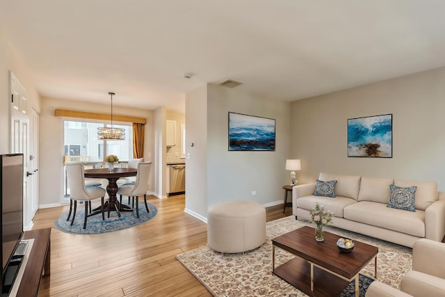 34309 N Goldenrod Rd, Round Lake, IL 60073 - living area featuring light wood-style floors, a chandelier, and baseboards