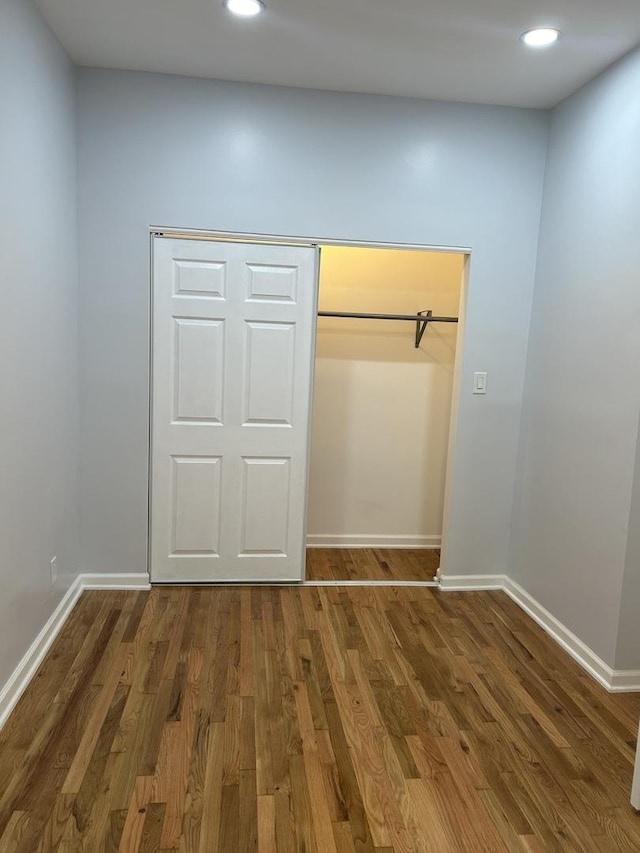 1122 N Mason Ave, Chicago, IL 60651 - unfurnished bedroom with wood finished floors, baseboards, recessed lighting, and a closet
