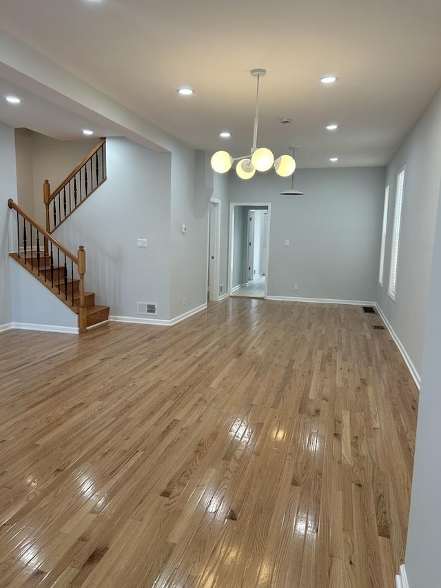 1122 N Mason Ave, Chicago, IL 60651 - unfurnished dining area with wood-type flooring, stairs, baseboards, and recessed lighting