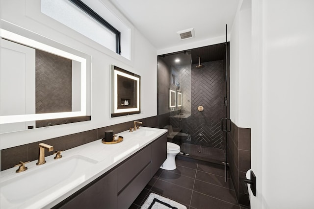 full bathroom with toilet, visible vents, a stall shower, and a sink