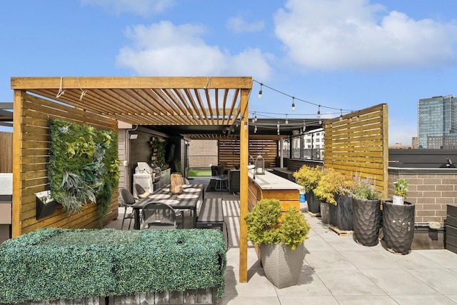 view of patio / terrace featuring a pergola and exterior kitchen