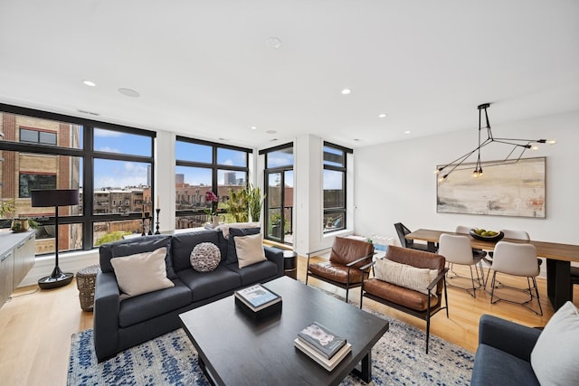 living room featuring light wood-type flooring and recessed lighting