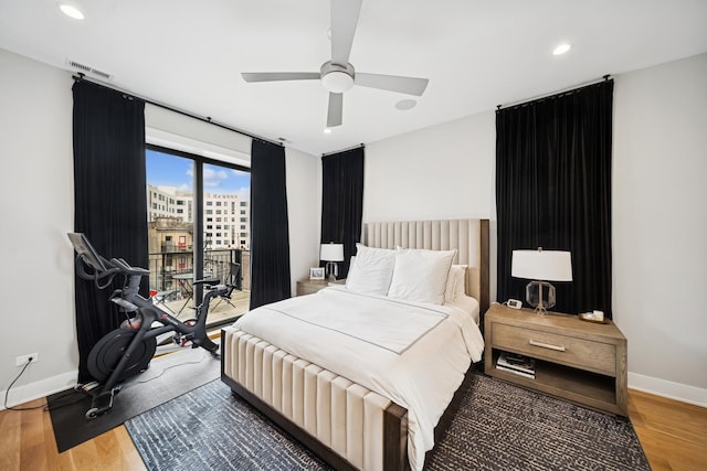 bedroom with wood finished floors, visible vents, recessed lighting, baseboards, and access to exterior
