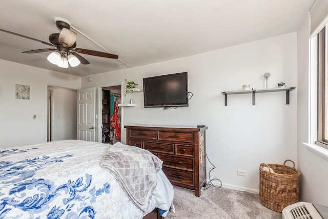 carpeted bedroom featuring baseboards and ceiling fan